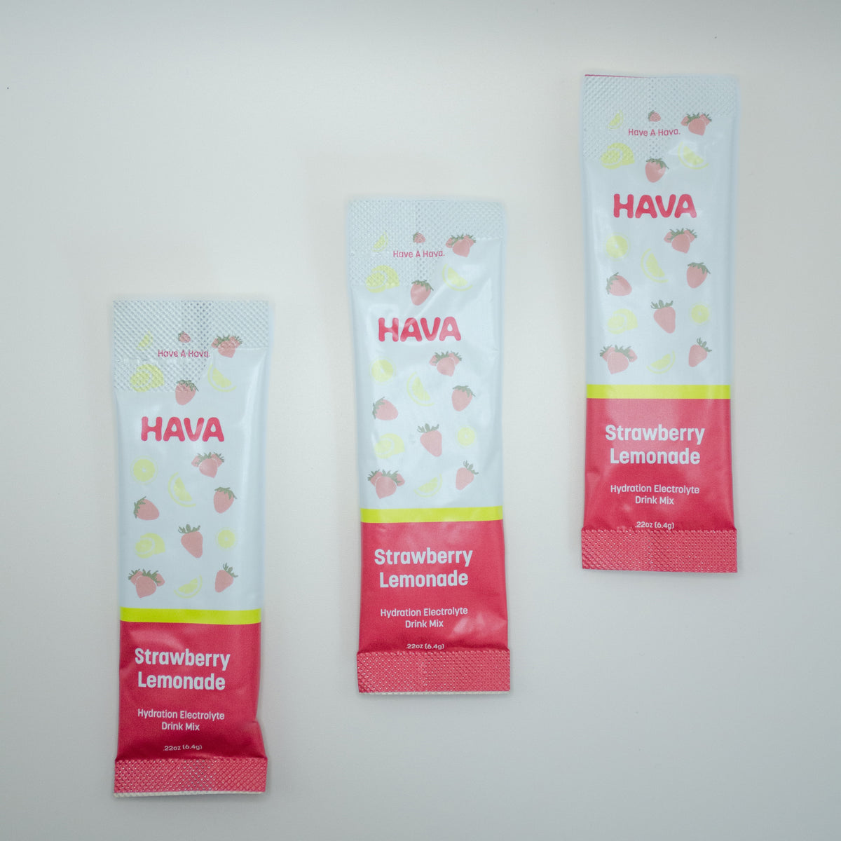 Three HAVA Strawberry Lemonade drink mix sachets in same sizes arranged vertically on a plain white background.