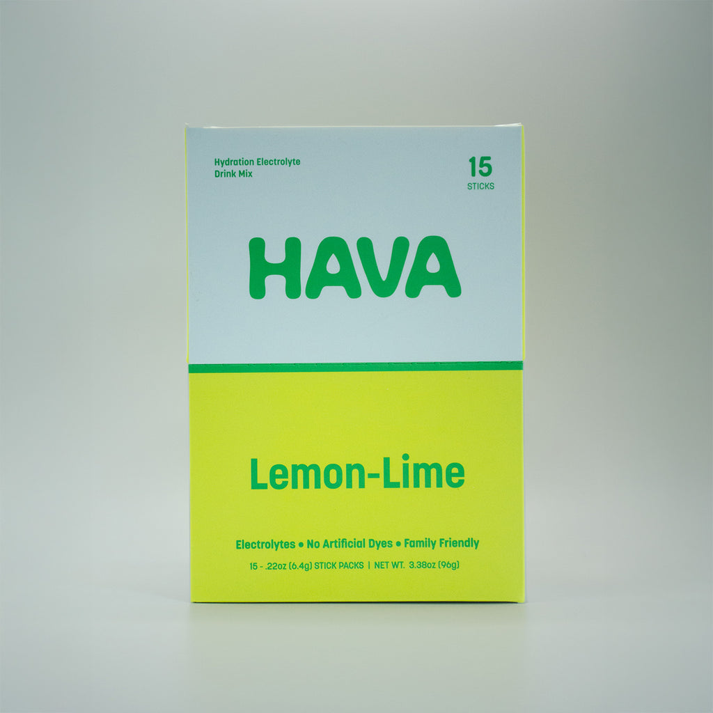 A box of Hava Lemon-Lime hydration electrolyte drink mix, featuring a white top half and a bright yellow-green bottom half with green text, photographed against a neutral light gray background.