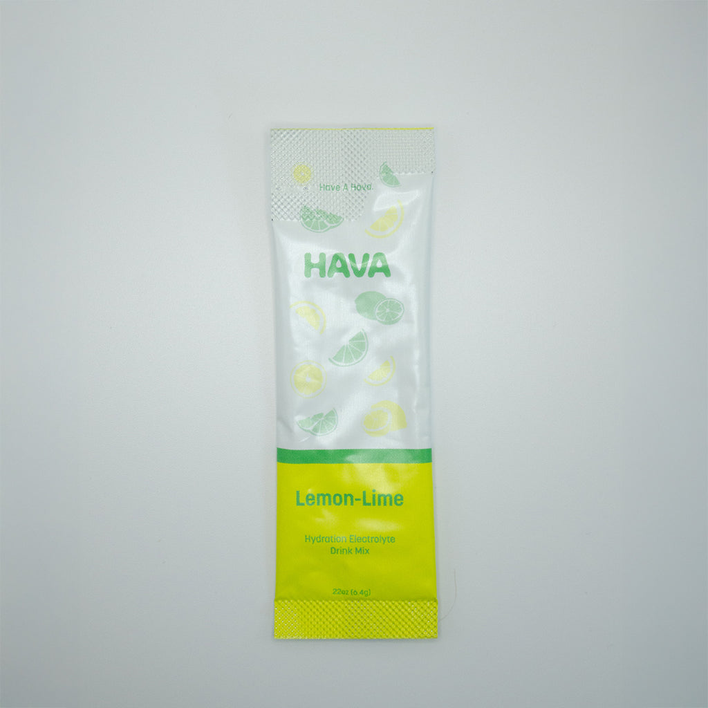 A single packet of HAVA Lemon-Lime Electrolyte mix, featuring a white and bright yellow-green design with illustrations of lemons and limes, set against a plain light gray background.